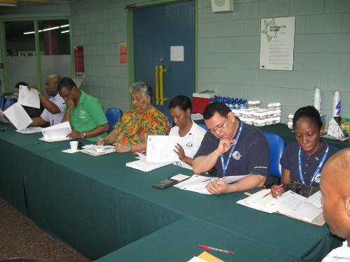 Lecturers review handouts for the ACCA Programme Committee Meeting